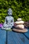 Budha figure with pyramide of stone of wooden background in the garden