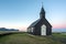 Budir church in Snaefellsness peninsula in the Icelandic countryside near Reykjavik during blue hour and sunset.