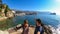 Budva - A couple taking selfies with panoramic view of the medieval old town of the coastal city of Budva