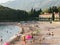 Budva, Montenegro - 01 august 2023: Tourists sunbathe on the sandy beach near Villa Milocer. Montenegro