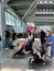 Budva, Montenegro - 12.07.22: Mothers with children in strollers stand in line at the airport lounge