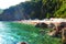 Budva, Montenegro, Mogren beach. August 15 2022 Sand and pebble beach near high cliffs. Beach umbrellas, cafes, deck