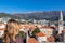 Budva - Rear view of woman looking at historic city centre and Venetion old tower of Budva seen from the Citadel