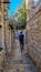 Budva - Tourist man walking in typical Mediterranean Street in the historic old city center (star grad) Budva, Montenegro