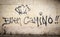 Buen Camino words and a shell painted on a wall