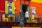 BUENOS AIRES / ARGENTINA - 05/04/2019: A man waiting on a red balcony in the famous italian Neighborhood of Caminito, Argentina