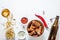 Buffalo style chicken wings served with cold beer on white wood background, top view with copy space