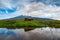 Buffalos in front of cloud covered Kerinci vulcano