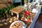 Buffet table full of food in small dishes and a fruit platter.