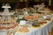 Buffet table with mini hamburgers, snacks, canape and appetizers at luxury wedding reception, copy space. Serving food.