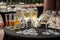 A buffet table on the terrace with glasses of champagne. Glasses of champagne stand on the terrace table