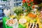 Buffet with a yellow-green tablecloth with snacks, desserts and a bouquet of tulips