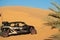 A buggy car parked in the Sahara desert sand dune