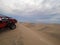 Buggy and sand dunes view rom the top of a dune