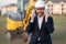 Buider man in suit and hardhat. Construction investor. Business man investor in front of construction site. Successful