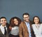 We build on each others strengths. Studio portrait of a group of businesspeople standing together against a gray