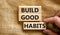Build good habits symbol. Concept words Build good habits on wooden blocks on beautiful canvas background. Businessman hand. Copy