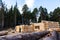 Build a house from logs. Preparation of logs for the assembly of the structure. Assembly of a wooden log house at a construction