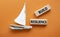 Build resilience symbol. Wooden blocks with words Build resilience. Beautiful orange background with boat. Business and Build