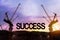 Build up success concept. Black alphabetic letters forming the word success being set up by group of construction machines