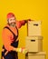 Build your future yourself. bearded loader in uniform. Cardboard boxes. moving to new house. purchase of new habitation