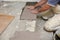 The builder arranges ceramic tiles on the stairs inside the building.