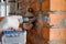 A builder attaches a construction suspension for drywall to a brick wall