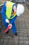 The Builder in blue uniform, measures the red pipe for laying electrical cables in parks, before pouring the Foundation of the