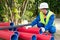 Builder checks the condition of red plastic pipes