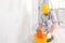 Builder damping a sponge in a bucket of water