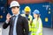 Builder Engineering in hardhat with radio communication over group of builders at construction site