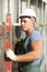 Builder facade plasterer worker with level