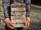 Builder hands holding old bricks