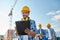 Builder in hardhat with clipboard at construction