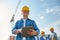 Builder in hardhat with tablet pc at construction