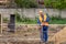 Builder makes a fence at the construction site