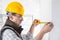 Builder marking off a measurement with a pencil