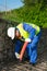 The Builder measures the red pipe for laying electrical cables in parks before pouring the Foundation of the road