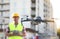 Builder operating drone with remote control at construction site. Aerial photography