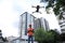 Builder operating drone with remote control at construction site. Aerial survey
