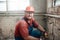 Builder in a protective helmet on a construction site working on a brick wall