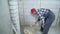 Builder putting plaster on aerated concrete block wall