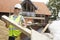 Builder Putting Waste Into Rubbish Skip