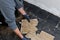 Builder removing damaged floor tiles