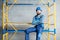 Builder on the scaffolding indoors