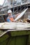 Builder On Site Putting Waste Into Rubbish Skip