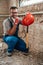 Builder sits on the smashed floor of the construction site