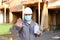 Builder with stopping gesture showing disinfectant and wearing mask with hardhat.