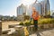 Builder using hand loader at construction site