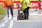 Builder using petrol powered road saw with dimond blade to cut asphalte road surface